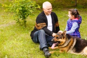 grandfather-and-granddaughter-relaxing-with-dog-2025-01-10-05-19-43-utc-min