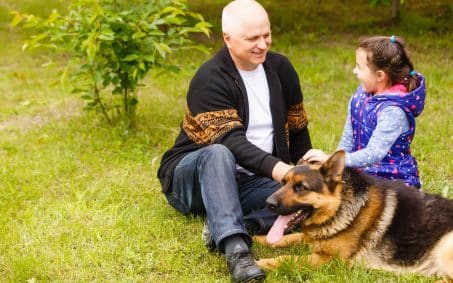 grandfather-and-granddaughter-relaxing-with-dog-2025-01-10-05-19-43-utc-min