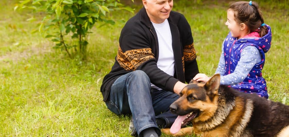 grandfather-and-granddaughter-relaxing-with-dog-2025-01-10-05-19-43-utc-min
